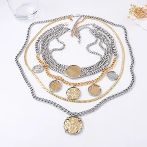 Multi-layer gold and silver chunky chain necklace with textured coin pendants