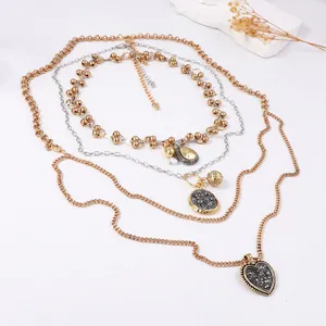 Multi-layer necklace set with mixed metal chains and heart pendant on white stone