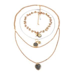 Chic multilayered gold chain necklace with geometric medallions and a heart pendant
