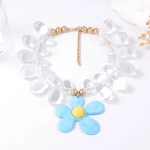 Close-up of translucent teardrop bead necklace with a large light blue flower pendant