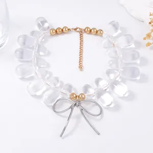 Detail view of acrylic teardrop beads and gold lobster clasp on a stylish necklace
