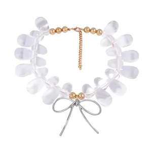 Detailed shot of beaded necklace with frosted waterdrop beads and silver bow pendant