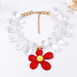 Detail of red flower pendant with yellow center and transparent resin waterdrop beads