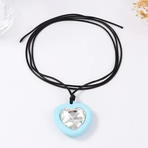 Détail macro du collier pendentif coeur bleu avec zircone cubique sur cordon noir