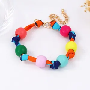 Colorful beaded fabric bracelet with adjustable gold chain and vibrant boho silk cord design