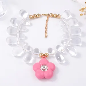 Detail of beaded necklace featuring water-drop beads and pink flower pendant with rhinestones