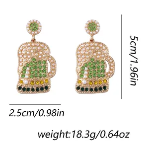 Detailed macro view of beer mug earrings with green rhinestones and white pearls