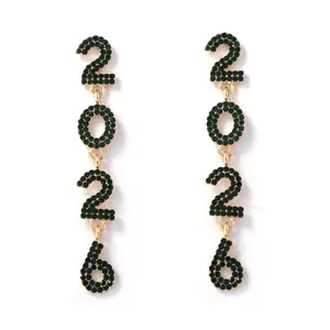 Detail of 2026 drop earrings featuring green rhinestones and golden alloy finish