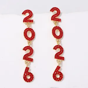 Macro shot of 2026 number earrings with sparkling red crystals on gold-plated alloy
