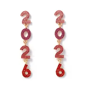 Close-up of 2026 number drop earrings with glittering red and pink crystal rhinestones