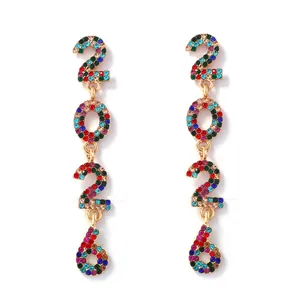 Macro shot of 2026 drop earrings with colorful rhinestones in golden alloy finish