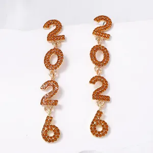Macro shot of gold-plated 2026 alloy drop earrings set with orange rhinestones