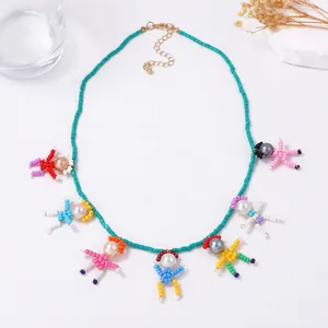 Detail of colorful handmade beaded necklace with quirky pearl figurines on teal beads