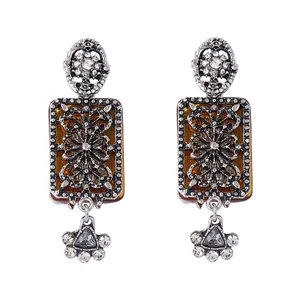 Detailed macro view of vintage geometric floral earrings with amber stones and crystals