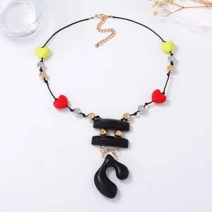 Bohemian beaded heart necklace with abstract black pendant on a white clean background