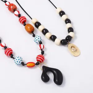 Handmade beaded necklaces with geometric pendants and colorful cord strings