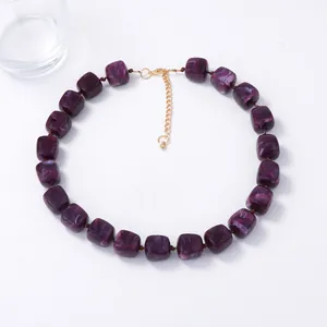 Minimalist purple resin cube beaded necklace with gold chain on a clean white background