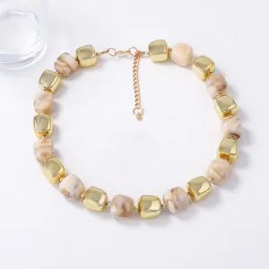 Close-up of geometric resin beads necklace with golden cubes and adjustable lobster clasp