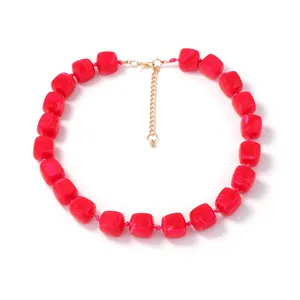 Detail of red marble-textured resin cube beads with gold adjustable lobster clasp