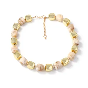 Minimalist beaded necklace with gold metal squares and marble resin cubes on white background