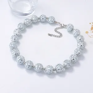 Close-up of shiny silver disco ball beaded necklace with lobster clasp and extension chain