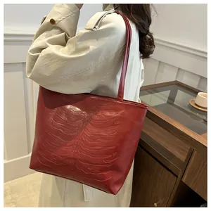Detail of red tote bag with unique 3D rib bone embossed pattern and glossy finish