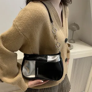 Fashionable black and silver color-block shoulder bag with floral metal chain strap