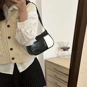 Fashionable black and white contrast color shoulder bag with chain strap and print