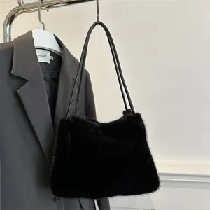 Minimalist black faux fur shoulder bag for women with sleek leather straps and plush texture
