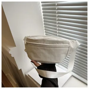 Close-up of minimalist white checkered chest bag with adjustable strap and zip closure