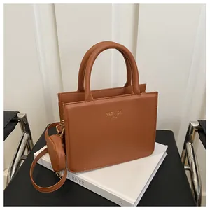 Caramel brown leather handbag with gold engraving and detachable round coin purse detail