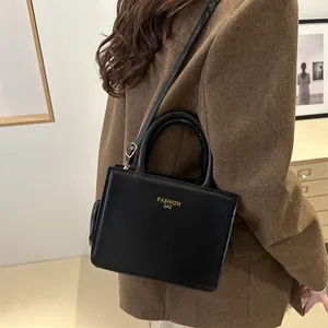 Minimalist black leather crossbody square bag with gold Fashion Bag print for women