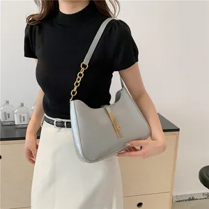 Chic gray crescent underarm bag with gold chain strap and buckle for casual commuting