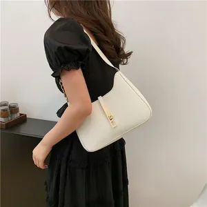 Minimalist white leather crescent shoulder bag with golden metal clasp for women's workwear