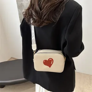 Chic beige crossbody square bag with red heart pattern and geometric pattern strap