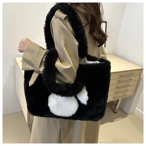 Plush faux fur tote bag in black and white shown with an autumn beige trench coat