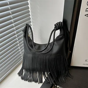Retro black leather hobo bag with long fringes and unique knotted handle design