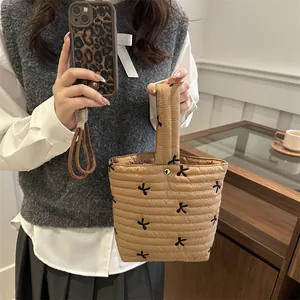 Quilted khaki handbag with black bow embroidery and silver clasp closure for women