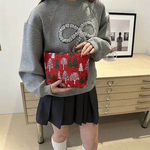 Red Christmas toiletry bag with festive pine tree prints shown in a lifestyle scene