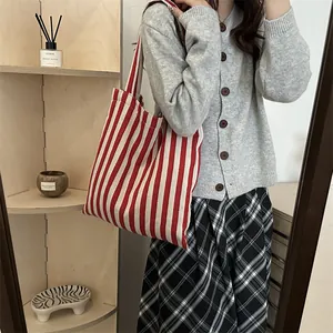 Minimalist red and white striped knit tote bag shown as a casual shoulder shopping bag