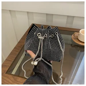 Detail of black drawstring bucket bag with sparkling silver rhinestones and pearls