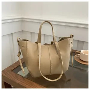 Close-up of beige lychee texture faux leather tote bag with drawstring side details