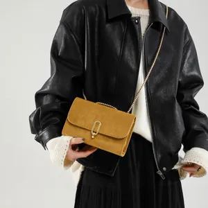 Fashionable mustard yellow crossbody square bag with gold buckle and chain strap