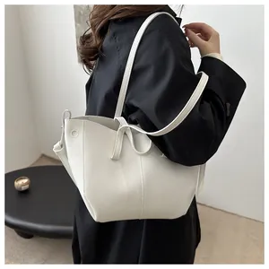 Detailed side view of white lychee pattern leather tote bag with unique folded structure