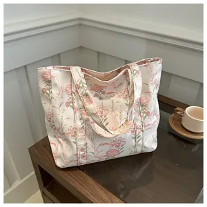 Close-up of floral pattern on canvas tote bag with pink flowers and green stems