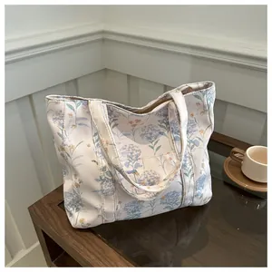 Close-up of canvas tote bag featuring fresh blue hydrangea prints and a large capacity