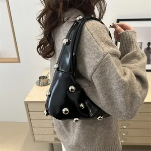 Black patent leather shoulder bag with large silver rivets for women's trendy fashion