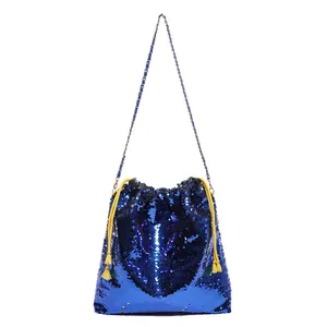 Blue sequin bucket bag with yellow tassel drawstring and gold chain shoulder strap