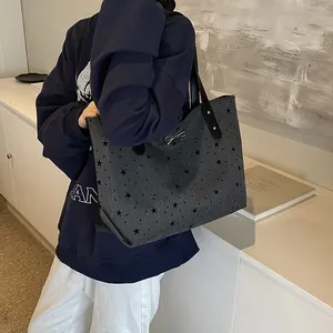 Large dark grey tote bag with black star patterns and silver bow decoration for daily commute