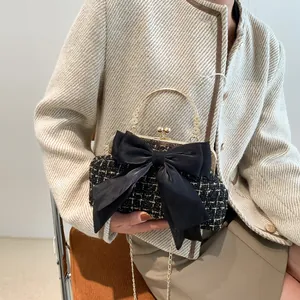Elegant woven tweed crossbody bag with large velvet bow and gold handle for women